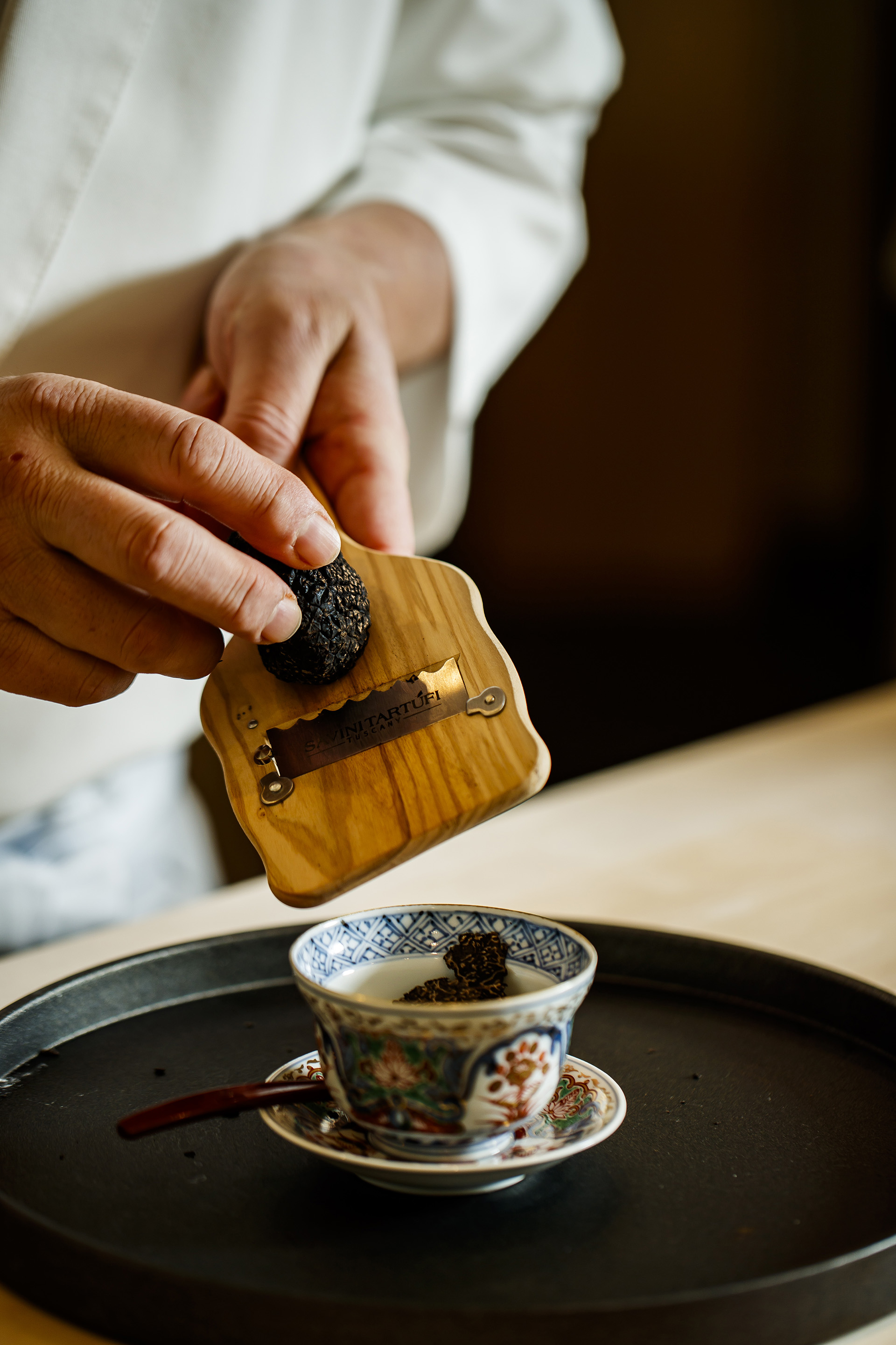 The chef shaving truffle over chawanmushi