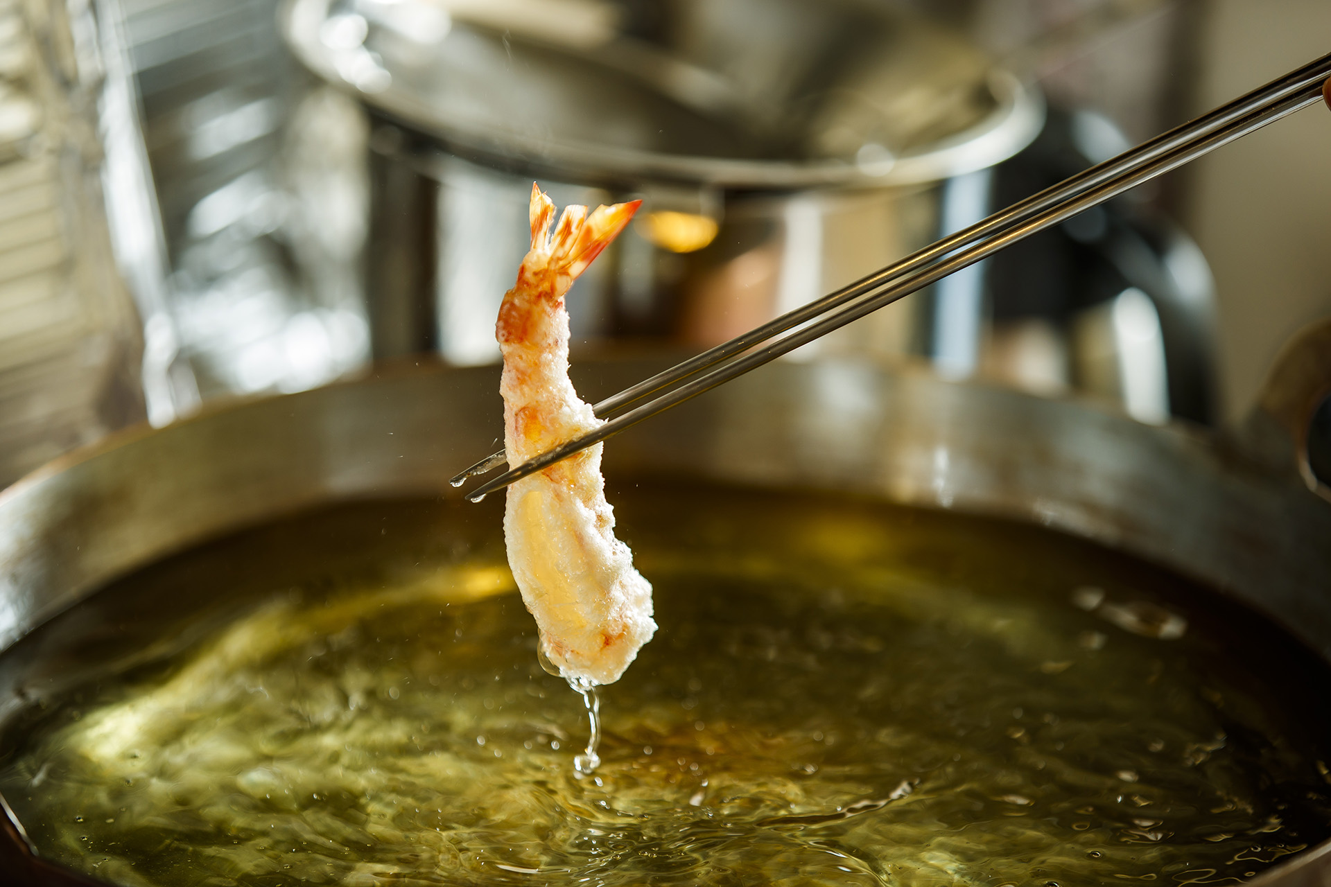 Prawn tempura lifted from the oil